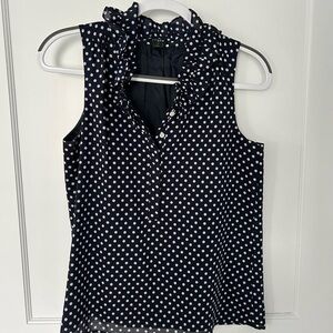 Navy sleeveless top with white polka dots, size 4